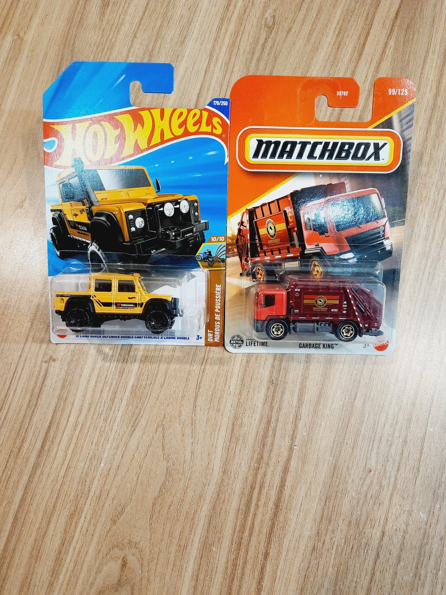 Hot Wheels 15 Land Rover Defender Double Cab & Matchbox Garbage King (combo pack of 2)