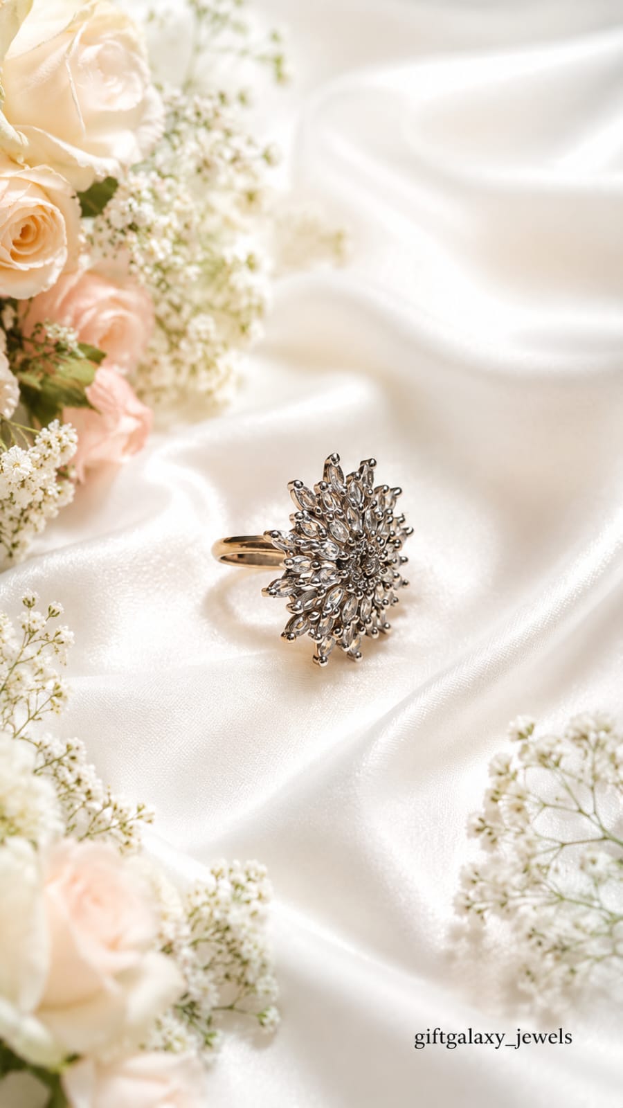 Hand wearing elegant silver crystal floral statement ring with pastel lavender nails and soft floral background.